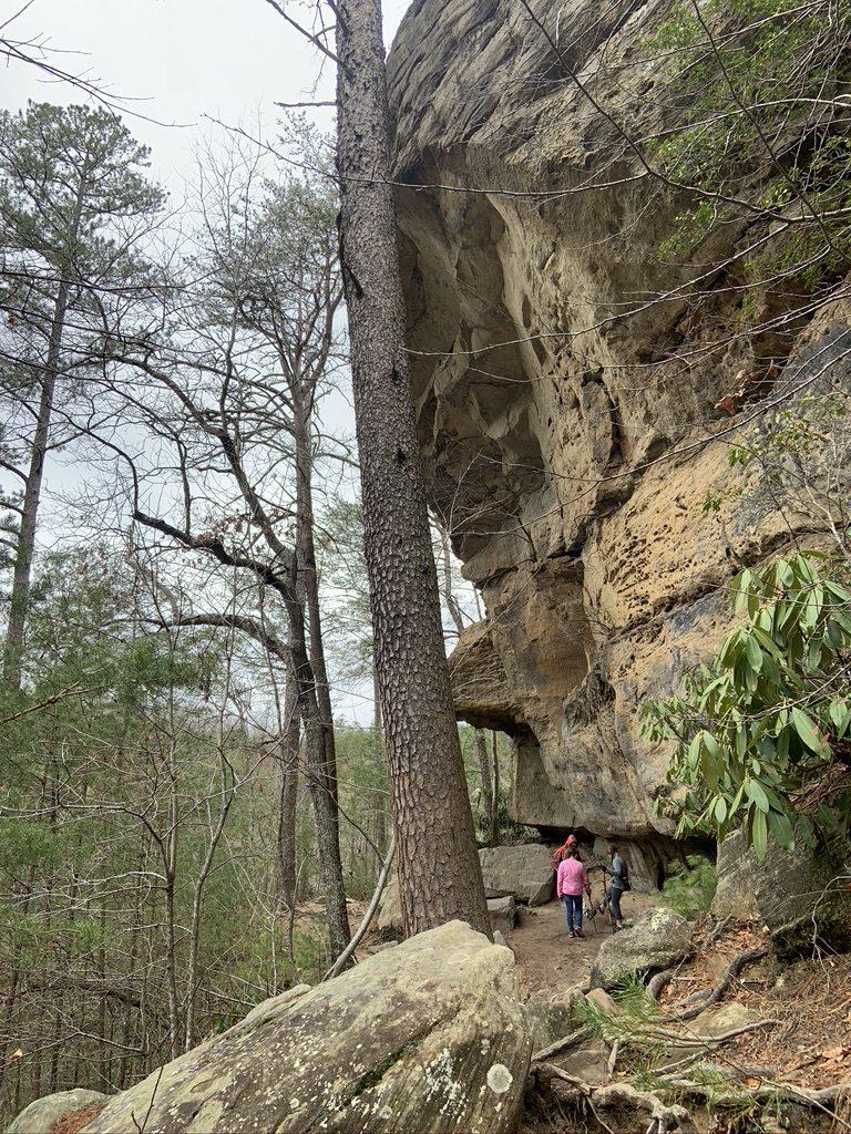 Hikers explore a sandstone cliff at Red River Gorge, Kentucky. Hiking with friends in Red River Gorge, KY.