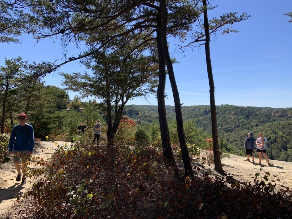 Hikers explore a scenic overlook in Red River Gorge, KY. Mystery hike adventures available!